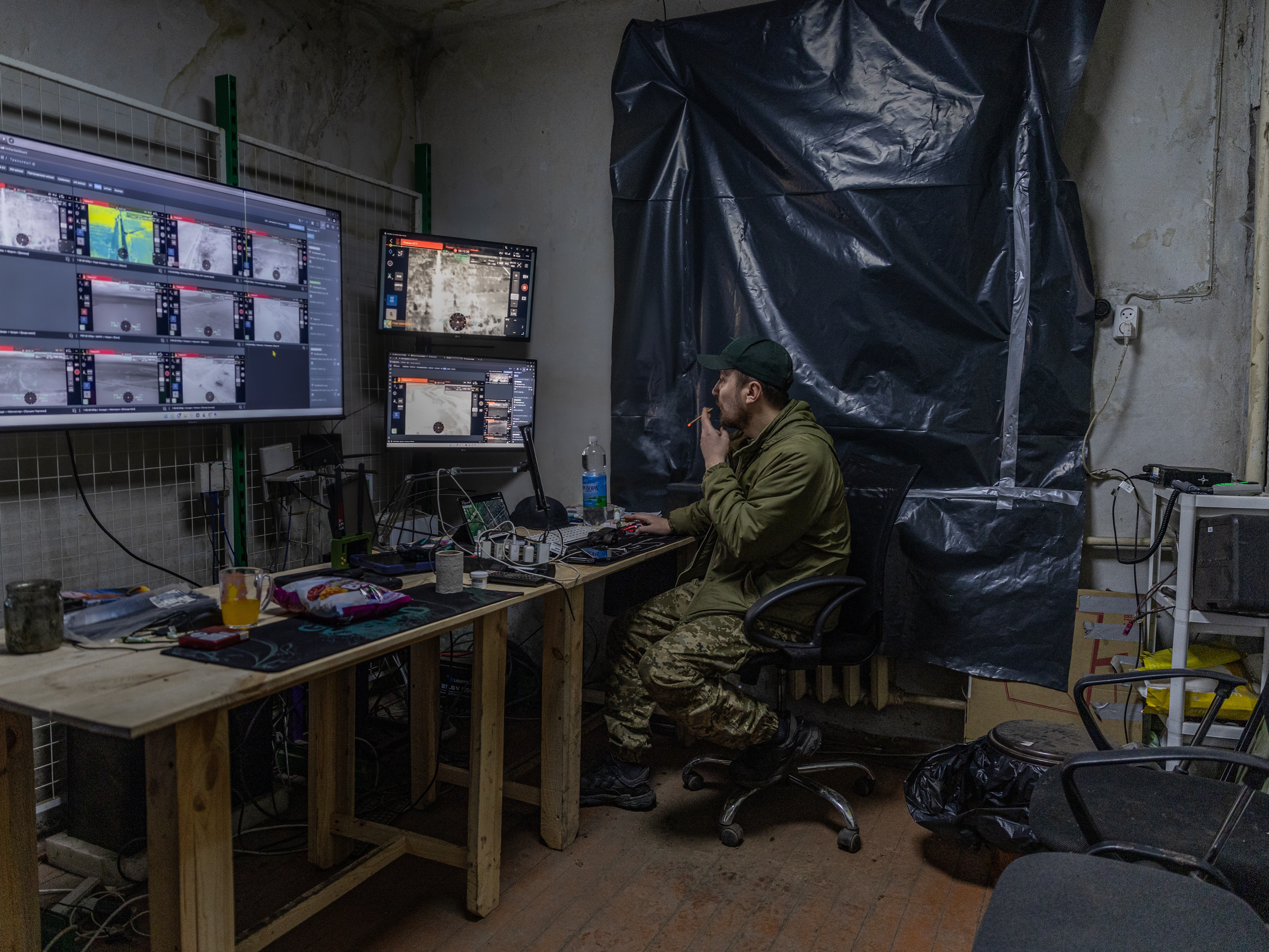 Callsign "Sonic", 34, a сommander of the strike unmanned aerial vehicle platoon, known as Dovbush's hornets, a unit of 68th Separate Jäger Brigade.  He watches the live streams of drone pilots operating in the Donbas Region on Dec. 19, 2024.