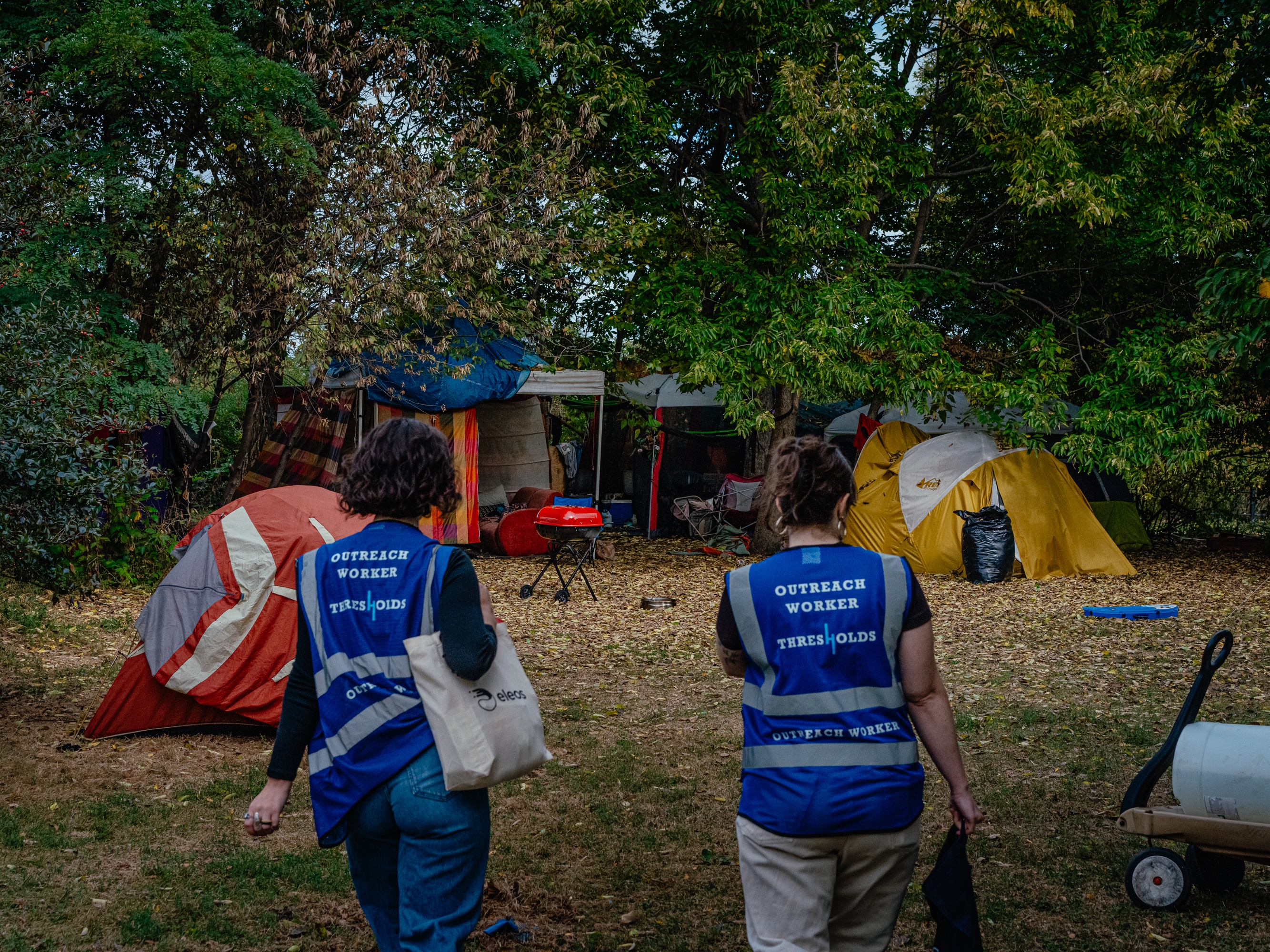 The burst of new laws follows a landmark U.S. Supreme Court ruling and reflects public frustration with record-high homelessness. Outreach workers Lillian Risser (left) and Sophia Loveland (right) approach a tent encampment in Chicago on Sept. 23, 2024. The organization is working to rehome people living in encampments to more permanent housing.