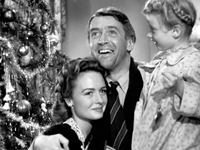 The movie "It's a Wonderful Life", produced and directed by Frank Capra. Seen here from left, Donna Reed as Mary Hatch Bailey, James Stewart as George Bailey and Karolyn Grimes as Zuzu. Premiered December 20, 1946.