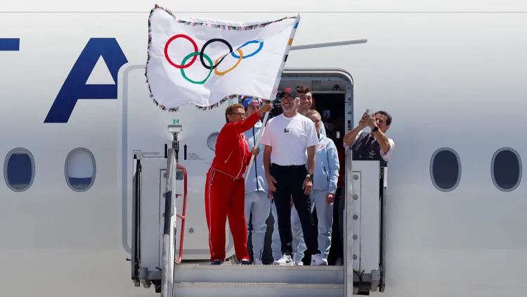 Mayor Karen Bass returned from Paris to LA on Monday, bringing the official Olympic flag with her.