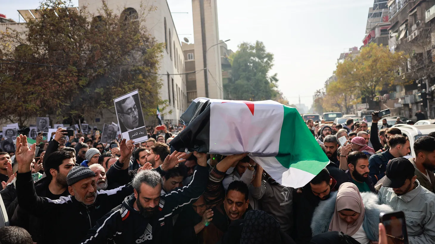 People carry the casket of Syrian activist Mazen al-Hamada in Damascus, Syria, on December 12, 2024 after rebels seized the city.